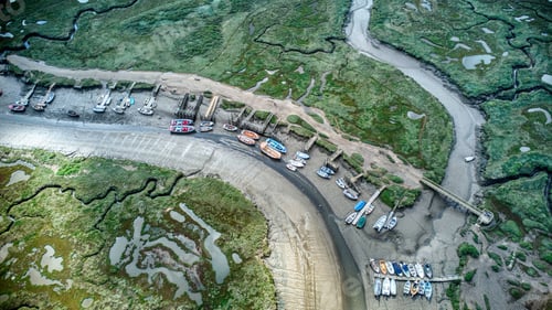 Preview: Aerial view of boats moored at a low tide on a dry river in rural Morston, Norfolk