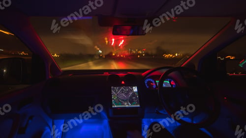 Preview: The man drive with a map on a rainy city. Evening night time. Left side traffic