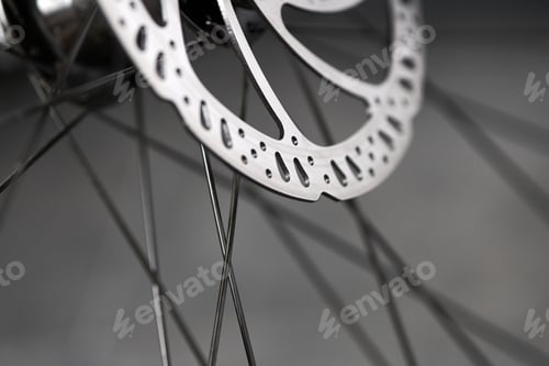 Preview: Bicycle disk brakes close up, metal disc attached to bike wheel, effective mountain bicycle brakes