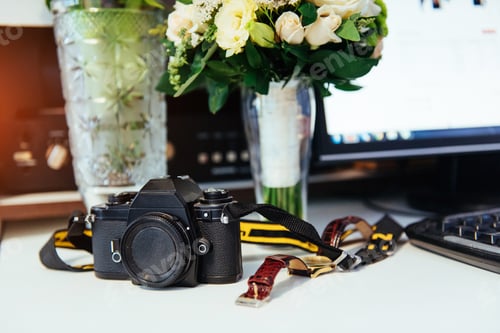 Preview: Photo retro camera on a table with different objects