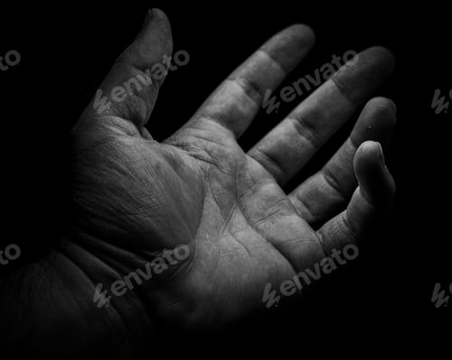 Preview: Grayscale shot of a human hand reaching out toward an unknown entity against a black background.