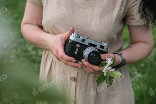 Preview: Vintage old camera in female hands