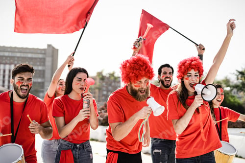 Preview: Football fans having fun supporting club on soccer match event at stadium