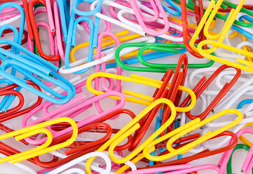 Preview: Stationery paper clips, multicolored close-up as a background. Stationery concept.