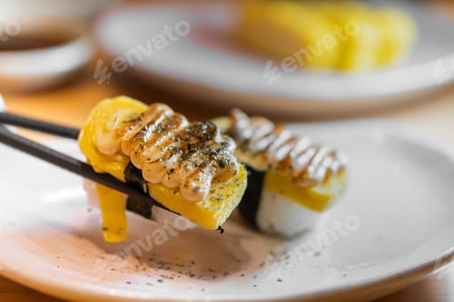 Preview: close up of sushi with chopsticks and soy