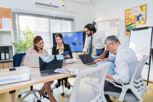Preview: Business Professionals Discussing Project in Modern Office