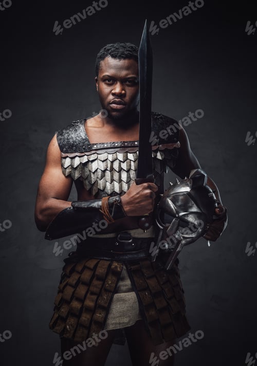 Preview: Studio shot of fearful authentic gladiator of african descent with gladius