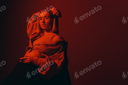Preview: Serene female model in dark studio