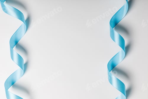Preview: top view of blue wavy silk ribbons on grey background with copy space
