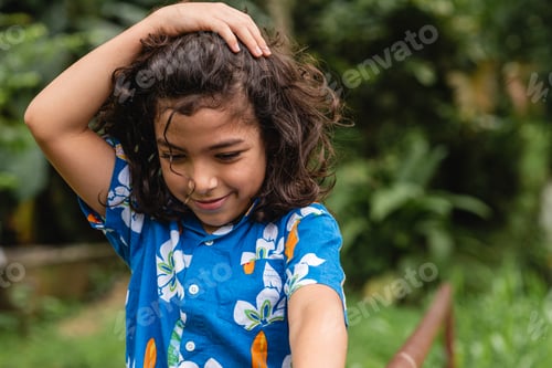 Preview: Happy boy standing near railing in park