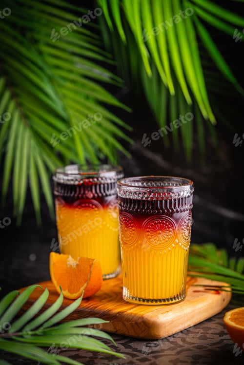 Preview: Closeup glass of cocktail with orange juice and red wine