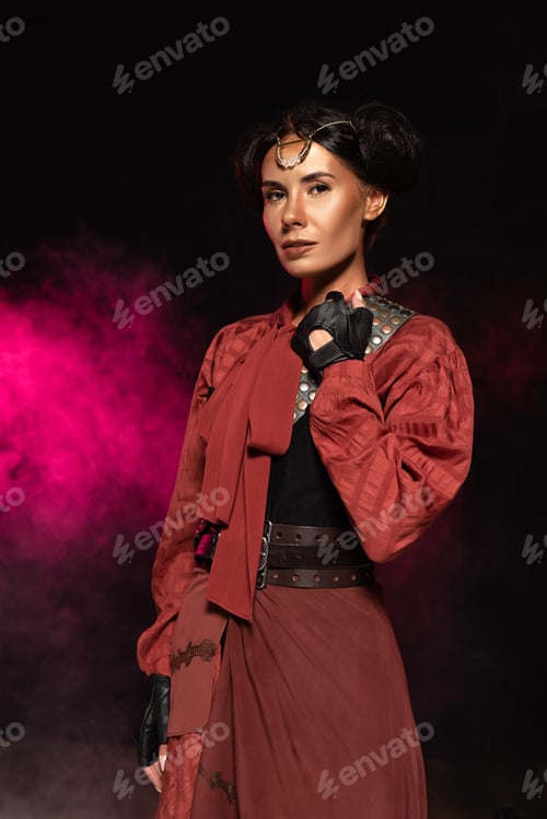 Preview: attractive steampunk woman looking at camera in smoke on black