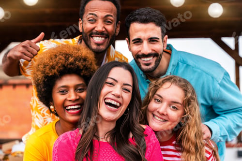 Preview: Multiethnic group of friends having dinner barbecue party on rooftop at home
