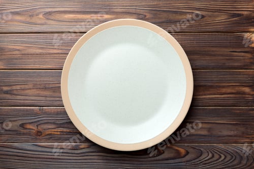 Preview: Top view of empty light plate on wooden background. Empty space for your design