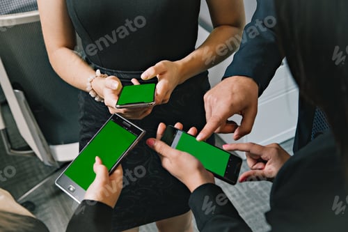 Preview: Business people using their smartphones with green screens
