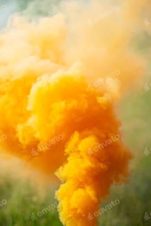 Preview: Bright Orange Smoke Rising from Ground Level. Smoke Bomb with Green Grass Background.