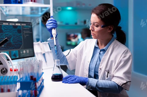 Preview: Scientist taking sample with micropipette wearing glasses