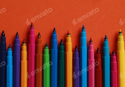 Preview: Set of felt tip pens on orange background, flat lay