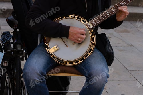 Preview: Closeup shot of a street musician playing the bandurria