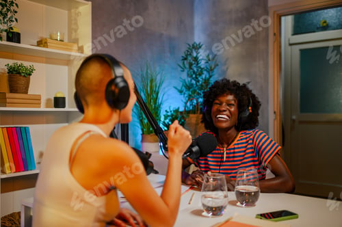 Preview: Two cheerful girls are sitting at home recording studio and making a podcast.