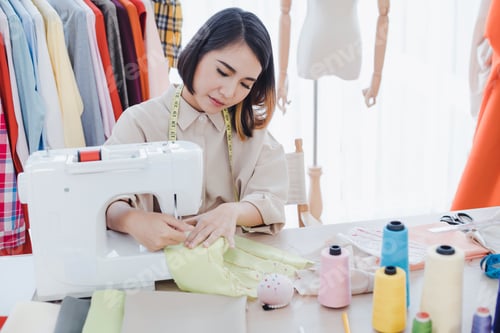 Preview: Designer using sewing machine in working.