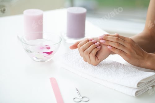 Preview: Happy woman making manicure when resting at home