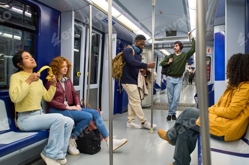 Preview: Diverse commuters traveling on a modern subway train