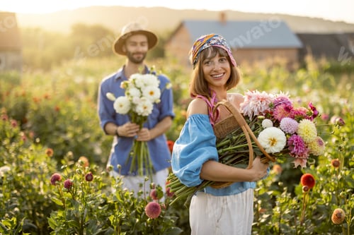 Preview: Lovely couple with dahlia flowers at garden outdoors