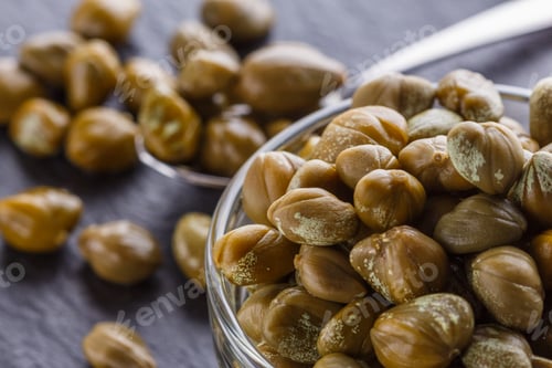Preview: pickled capers on a dark stone background