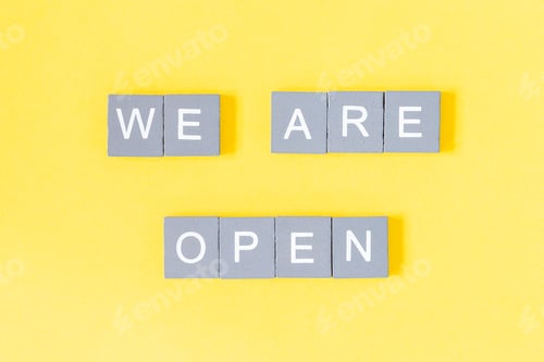 Preview: We are open quote, welcome sign for business or caffe, wooden letters on yellow background