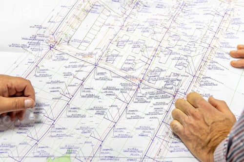 Preview: Male hands lie on project of engineering networks for gas supply to cottages in private sector.