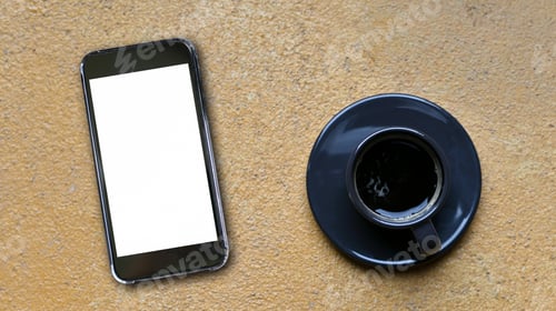 Preview: Mockup blank screen smartphone and coffee mug place on yellow concrete floor,Top view shot.