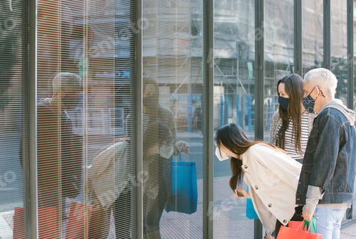Preview: Group of friends looking at showcase in city