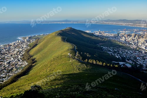 Preview: Green mountain overlooks a city from a distance with the ocean, the southern point of Africa