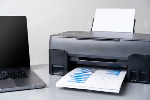 Preview: Printer and laptop on grey table in office