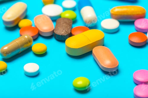Preview: Colorful collection of different pills and capsules on a flat surface in bright light