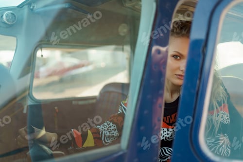 Preview: Young woman passenger in a small plane