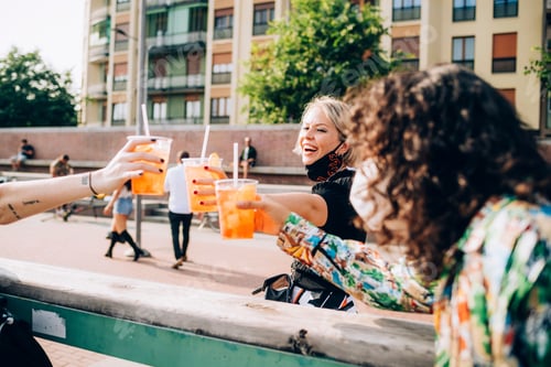 Preview: Friends sharing a toast with refreshing drinks on a sunny day