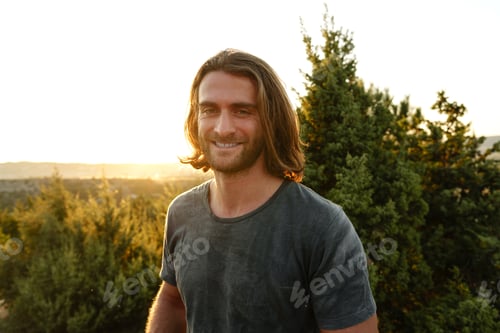 Preview: Casual man hiker outdoors in gray T-shirt outdoors portrait