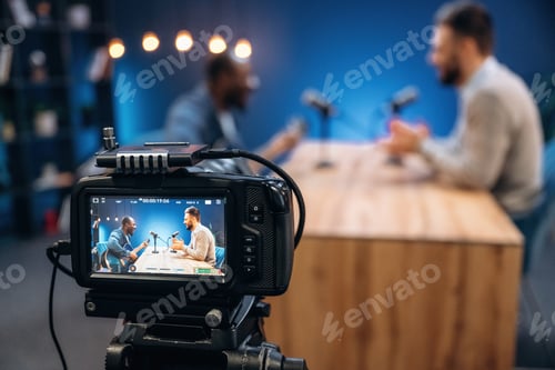 Preview: Interviewing the musician. Two radio presenters recording an audio broadcast in a studio