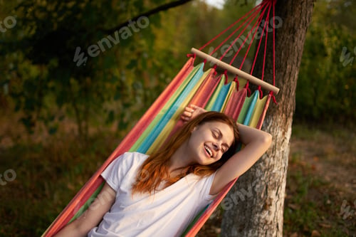Preview: woman outdoors lies in a hammock vacation summer