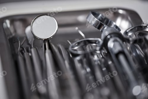 Preview: Macro shot of metal sterile tools set with mirror in dental clinic