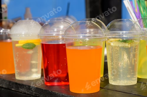 Preview: Different colors of cold water in a plastic cup.