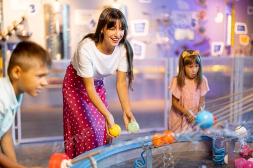 Preview: Mom with kids playing in a science museum