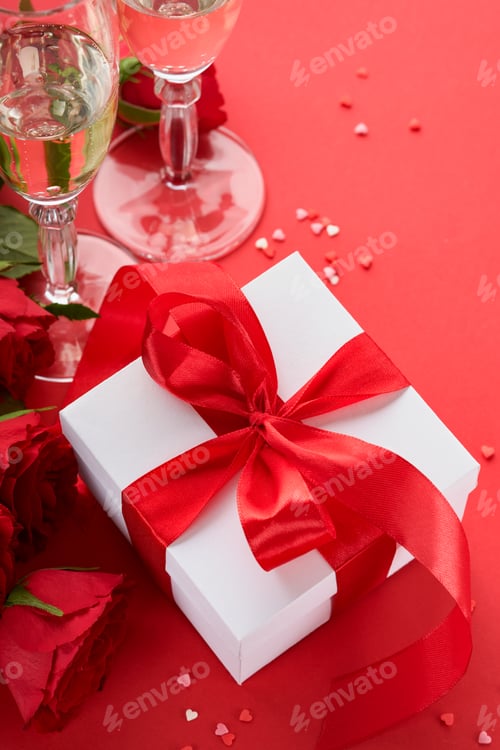 Preview: Valentines Day or Romantic dinner concept. Romantic table setting, silverware, wine glasses, gift bo