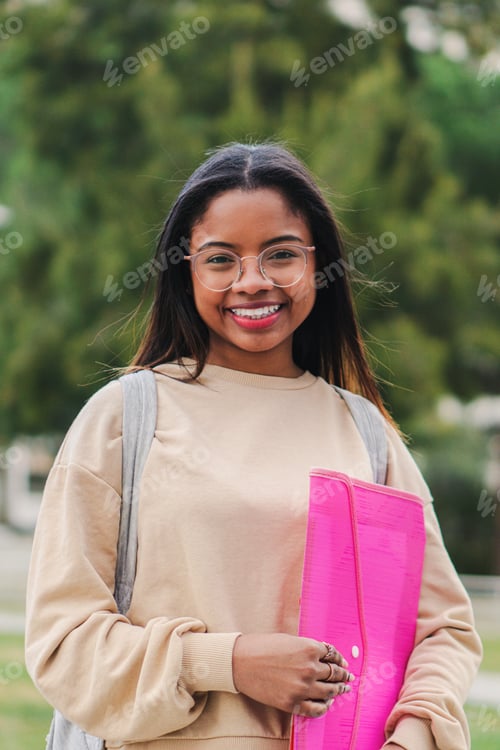 Preview: Vertical individual portrait of a happy hispanic smart school girl with glasses smiling and laughing