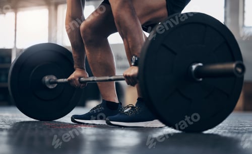 Preview: Closeup shot of an unrecognisable man exercising with a barbell in a gym