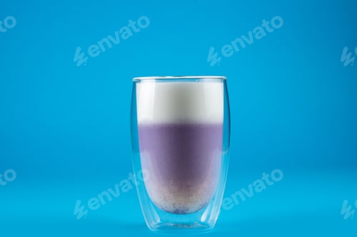Preview: Purple goji matcha served in double glass, refreshing blue background drink.