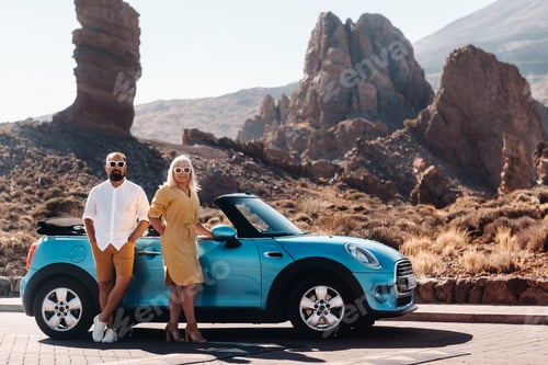 Preview: a woman and a man wearing glasses in a convertible car on a trip to the island of Tenerife. The