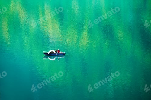 Preview: Fishing from a boat. Boat on the lake and reflections on the surface. Summer holidays and hobbies.